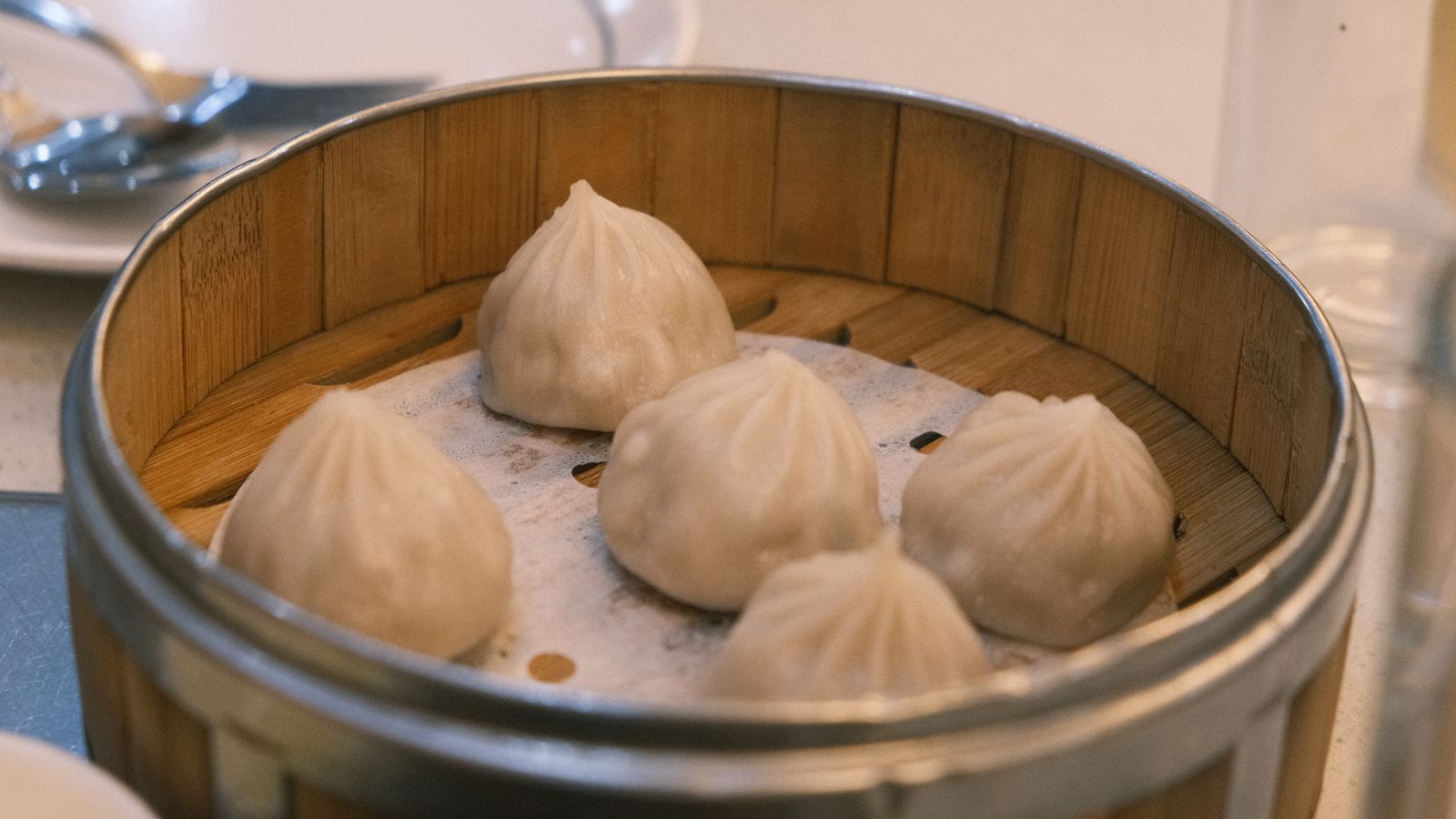Steamed dumplings in a bamboo steamer basket